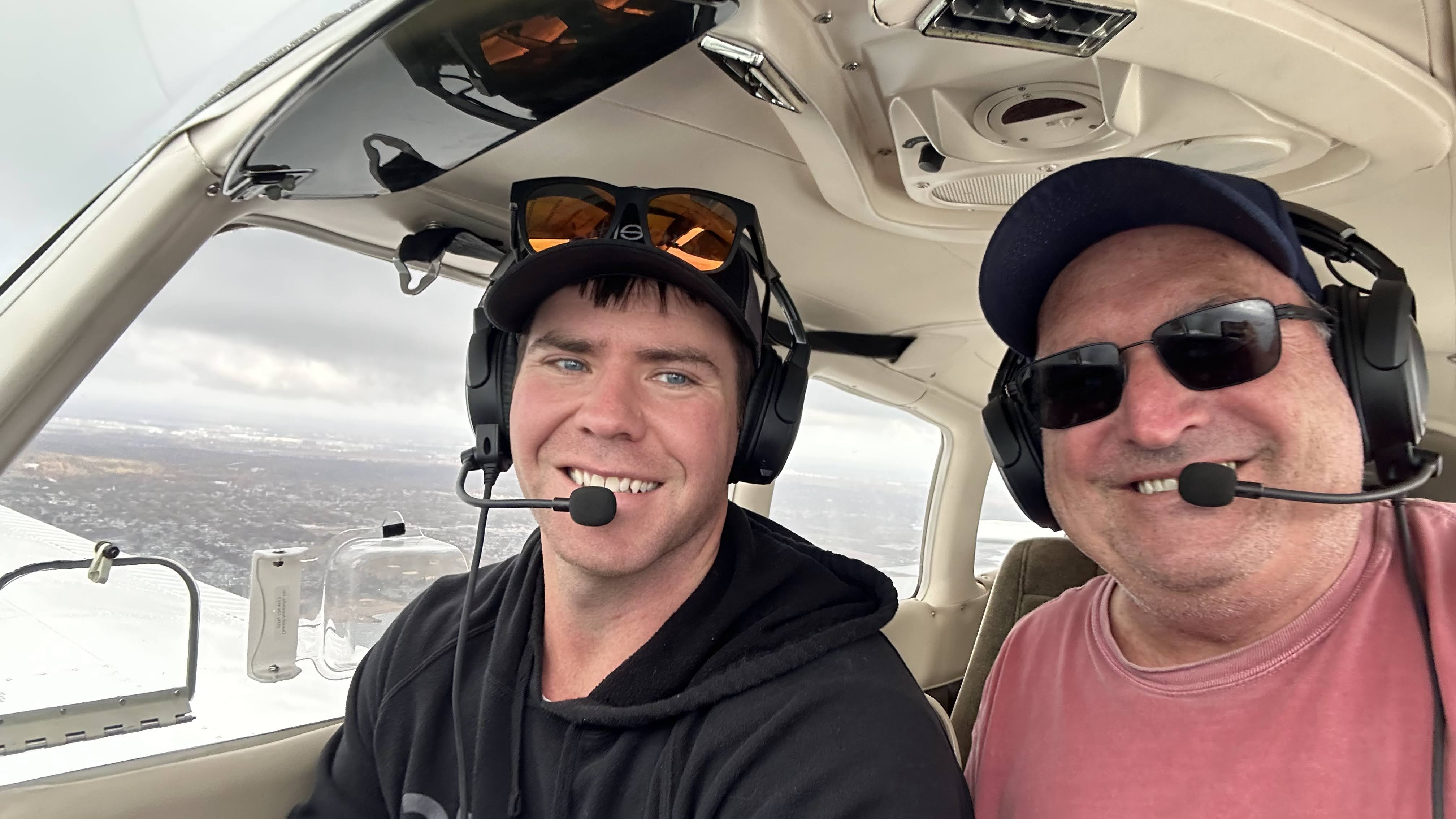Josh and Bruce sharing a flight, smiling in the cockpit